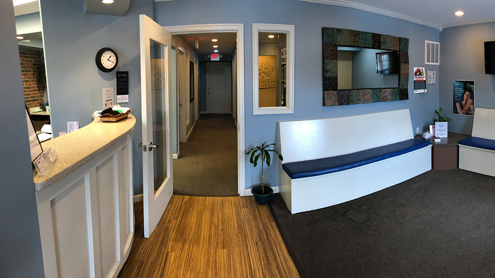 Waiting room with calming light blue walls in Amherst orthodontic office