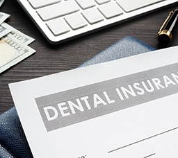 Dental insurance form on messy desk