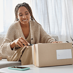 Girl wearing braces and opening box with tool