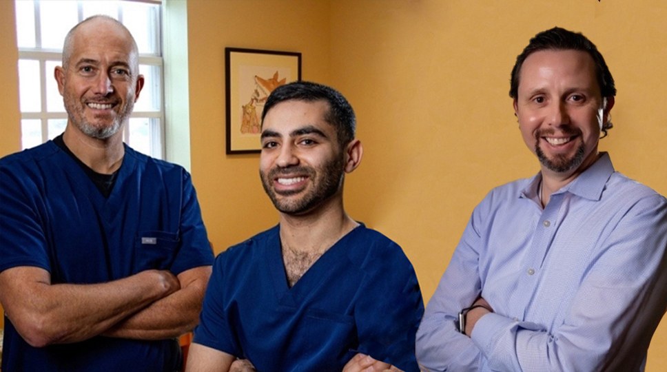 Four smiling orthodontists in Western Massachusetts standing with arms crossed