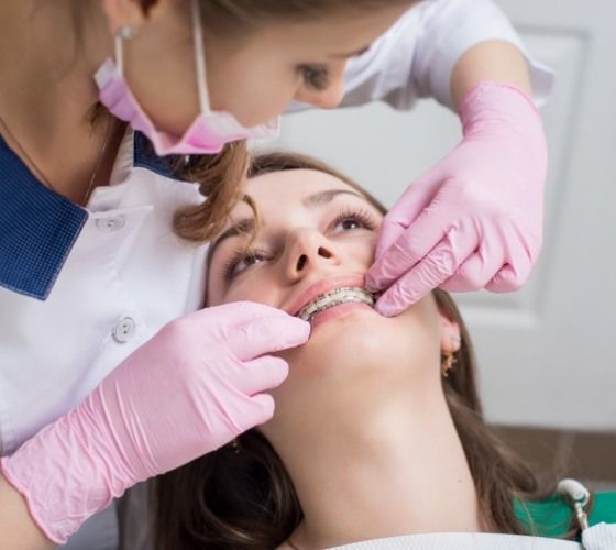 Orthodontist examining a patient with braces