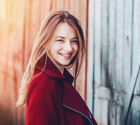Young woman in red jacket smiling