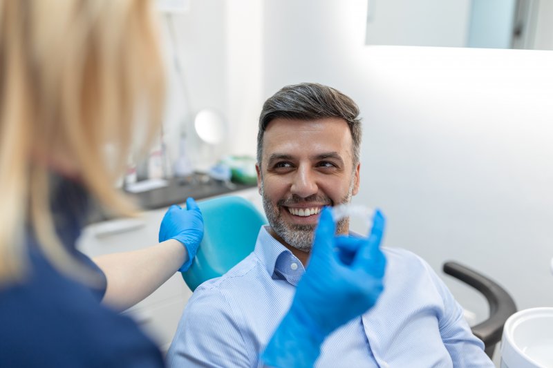 older man seeing an orthodontist for Invisalign