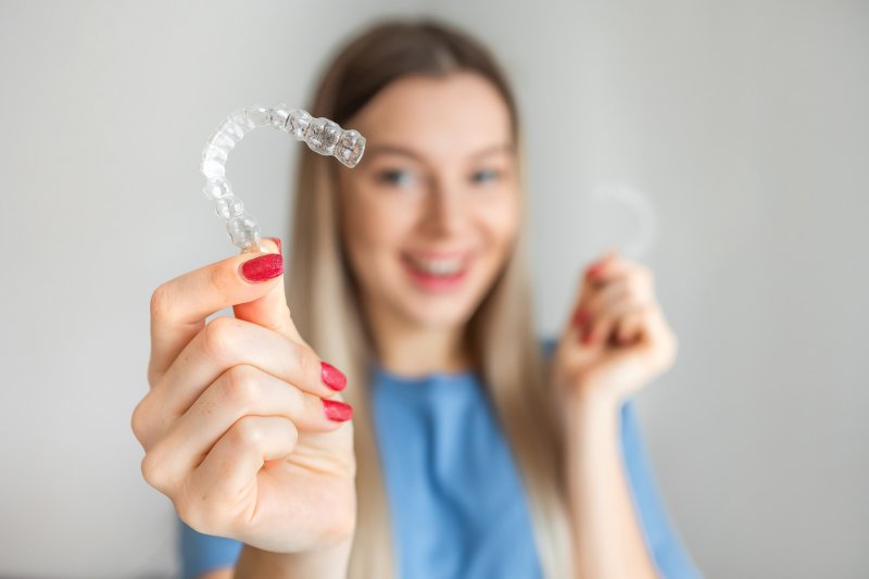 patient holding a clear aligner